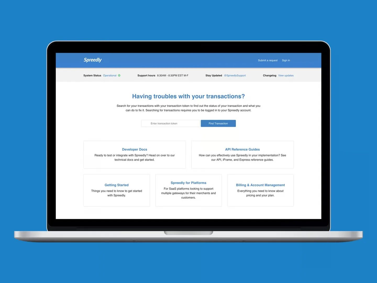 Spreedly support site on a laptop: system status bar, a transaction token search, and cards for developer docs, API guides, getting started, platforms and billing